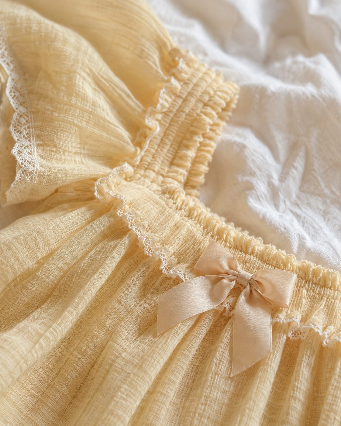 Close detail of yellow gauze ruffle and satin bow